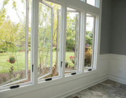 A row of open casement windows on a wall in a home.