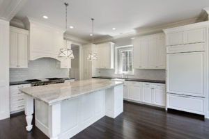 Kitchen in luxury home with white cabinetry.