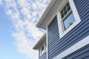 Gorgeous vinyl siding on a house with the bright blue sky in the background