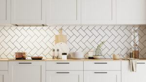 Close-up view of white kitchen cabinets and a white backsplash