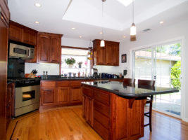 Cherry-colored, wood kitchen cabinets