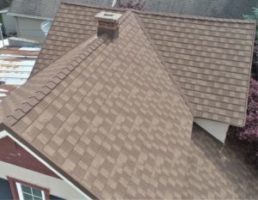 A brown metal roofing system that looks like asphalt shingles.