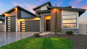 A modern home with sleek windows, siding, and garage doors.
