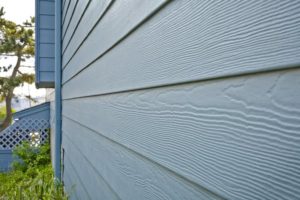 A close up of fiber cement siding on a home