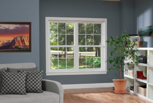 The interior of white single hung windows installed in a blue wall.