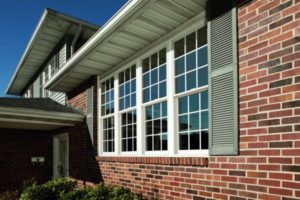 Close-up view of a new vinyl window on a home with brick siding